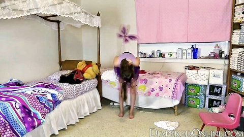 Diapered girl bends over in nursery showing thick padded diaper ass