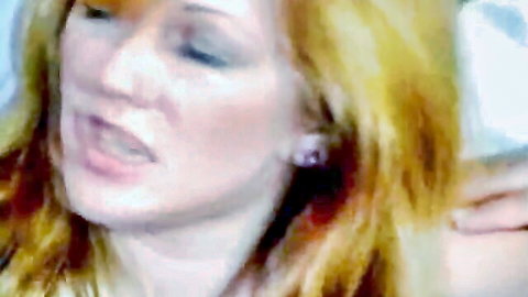 Blonde woman with open mouth moaning in ecstasy during intense blowjob.