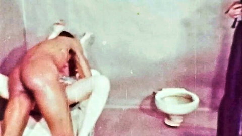 Uniformed woman whips naked man's bare ass bent over prison toilet
