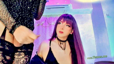 Purple-haired shemale in black lace lingerie and choker gesturing seductively
