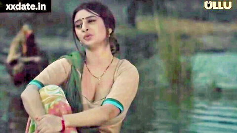 Busty Indian housewife in wet saree blouse showing deep cleavage in river