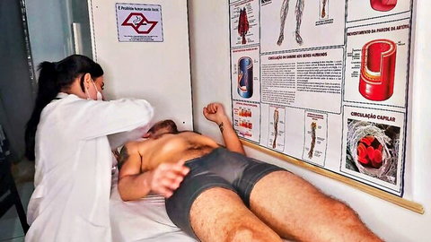 Latina nurse in white coat examines patient's visible erection during medical check