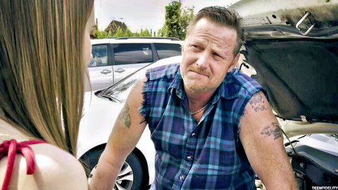 Jill Kassidy chats with tattooed mechanic by car hood
