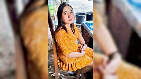 Viral Indonesian es dawet seller in orange floral dress, smiling outdoors