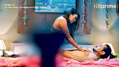 Indian woman in black outfit straddling man in cowgirl position on bed