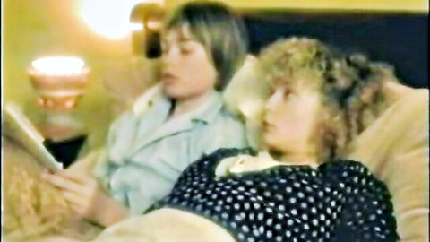 Vintage mom-son family porno: curly-haired woman and young man reading in bed