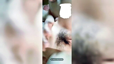 Blurry close-up of Asian woman's exposed pubic area with dark hair, censored