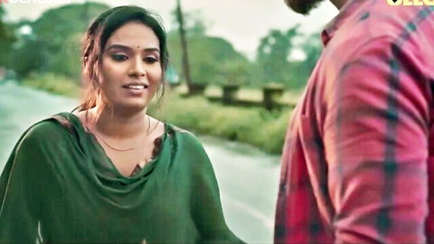Desi bhabhi in green saree smiling at man outdoors