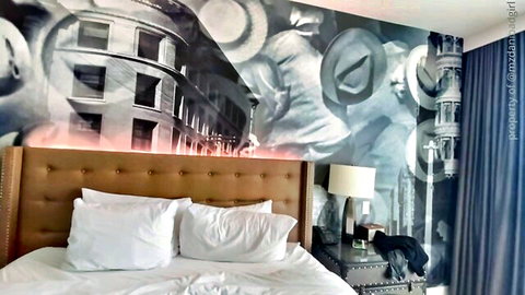 Luxury hotel bedroom with artistic coliseum mural for THICC PAWG scene