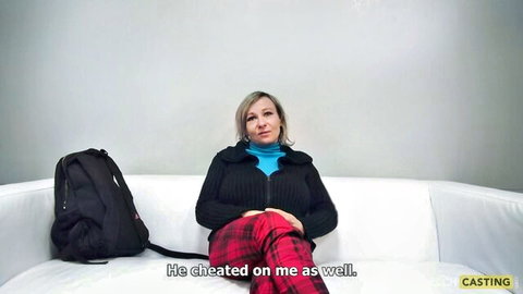 Blonde MILF on casting couch in cardigan and pink pants complaining about cheating boyfriend