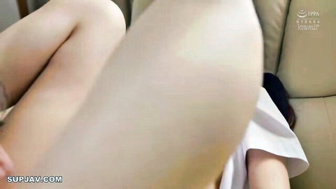 Japanese teen pulls up white shirt exposing huge tits while spreading legs wide on couch