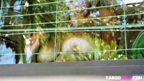 Tanned MILF squishes huge bare tits against foggy greenhouse window exposing erect nipple