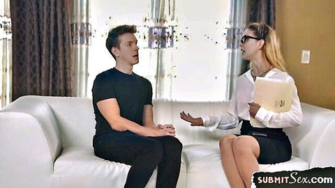 Blonde MILF in glasses blouse skirt and stockings talks to young guy on couch