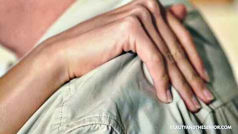 Angela Allison's hand gripping older man's shoulder in intimate embrace