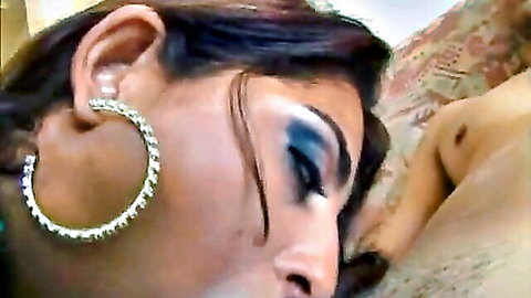 Seductive Brazilian woman close-up with bold makeup and hoop earrings in big ass anal scene