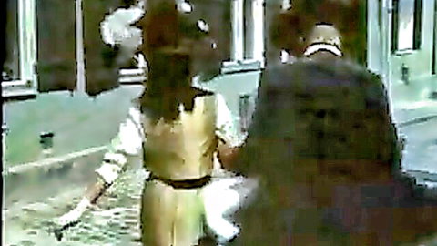 Josefine in vintage gold dress walks with suited man in classic erotic film scene