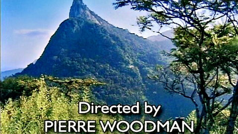 Caroline Cage in Indecency (1998) by Pierre Woodman, scenic outdoor mountain view