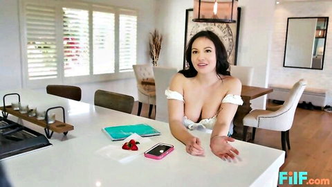 Busty Kylie Page smiling with deep cleavage in off-shoulder top