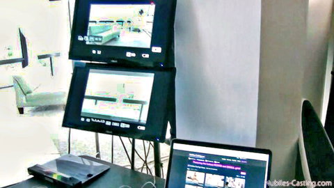 Stacked monitors displaying empty green casting room setup for amateur porn auditions at nubbles-casting.com