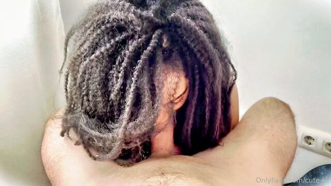 Rear view of nude dreadlocked woman kneeling, OnlyFans amateur tease