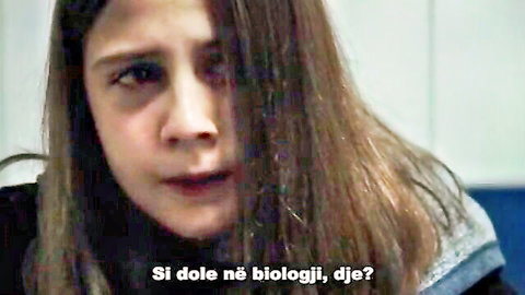 Emotional brunette teen in amateur drama scene, long hair, intense gaze