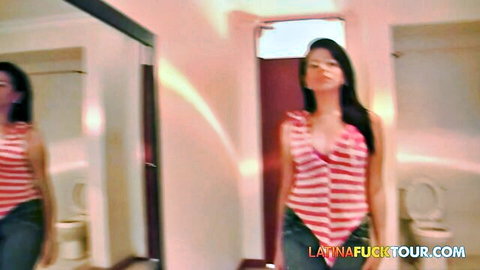 Shy amateur Latina teen in red striped top and jeans posing in mirror