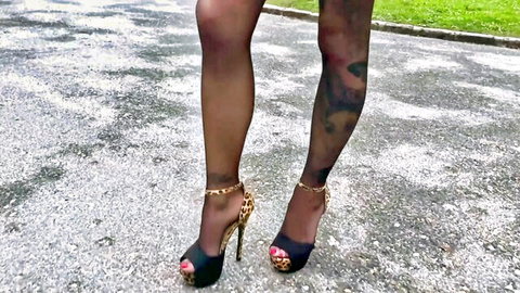 Angela's tattooed legs in sheer black stockings and leopard heels