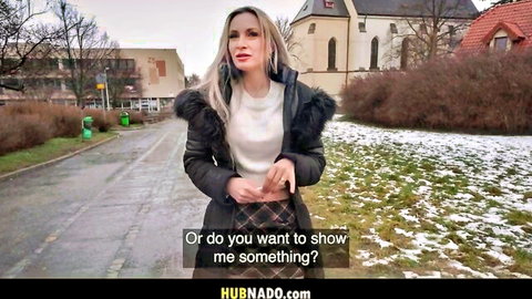 Busty blonde Micky Muffin teases outdoors in fur coat and plaid skirt