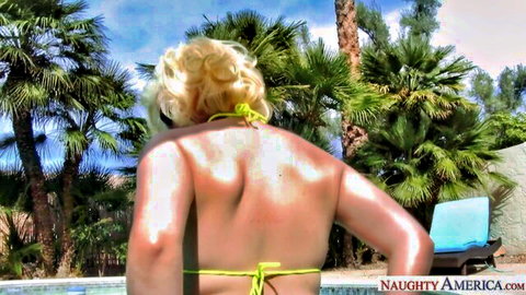 Jenna Ivory blonde in yellow bikini bottoms, topless poolside back view