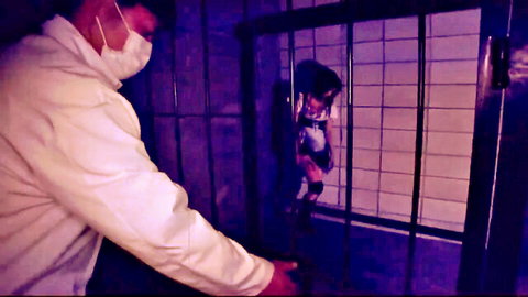 Big tits zombie girl in cage with masked man approaching