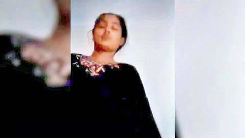 Seductive Indian woman in black embroidered top, teasing expression