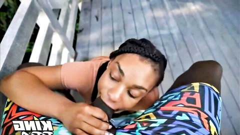 Ebony woman with braids gives outdoor blowjob to BBC on porch