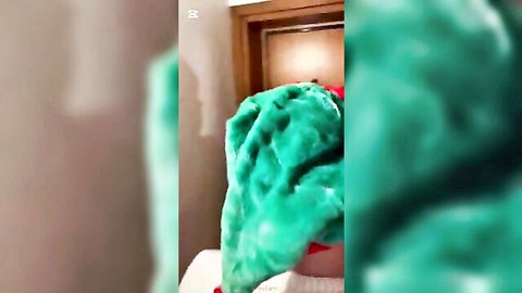 Blurry festive Christmas orgy scene with green fur costume and hidden figure