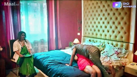 Indian doctor in saree bent over bed with man behind in steamy scene