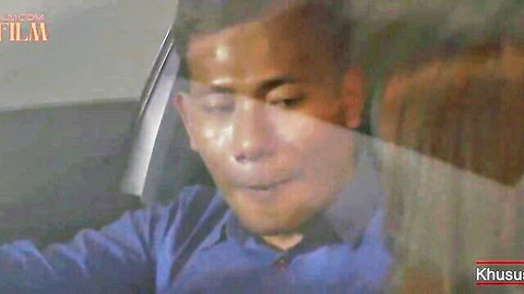 Sweaty Asian man in blue shirt inside car, intense expression from Film Kelas Bintang Squirt Part 1