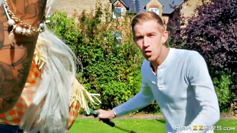 Blonde Brooklyn Blue in feathery outfit teased by man outdoors, Brazzers scene