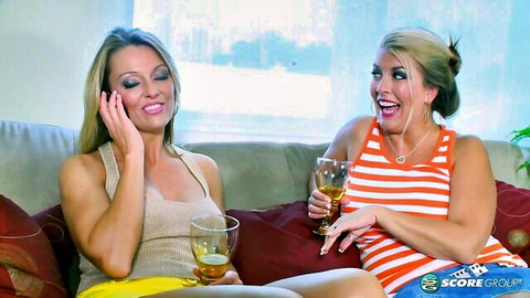 Busty blondes sipping drinks on couch in Home Delivery scene