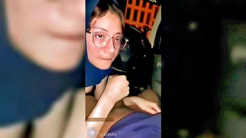 Noor Aini in hijab giving blowjob in Indonesian car, amateur oral sex