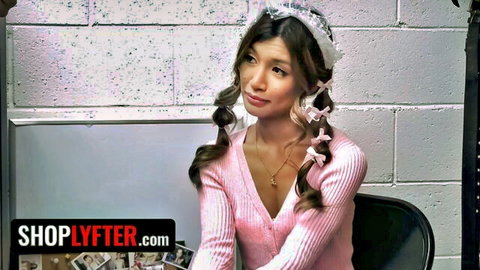 Clara Trinity as petite Asian thief in pink sweater and pigtails, ShopLyfter scene