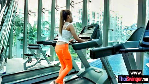 Hana in tight orange leggings on treadmill, gym stretching tease, Asian fitness babe
