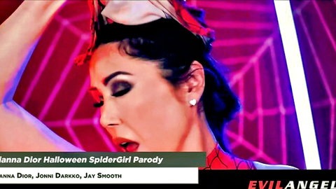 Seductive brunette Jenna Dior in tight Spider-Girl Halloween cosplay parody, teasing with open mouth and curvy body