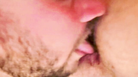 Bearded gay man passionately French kissing lover with tongues intertwined closeup