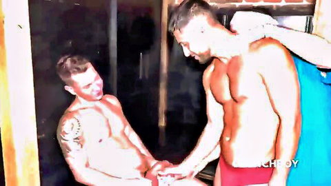Muscular tattooed gay hunks in tight briefs grab each other's bulging cocks in steamy shower