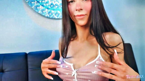 Stunning trans star Layla Babi in sexy pink top, teasing cleavage solo pose