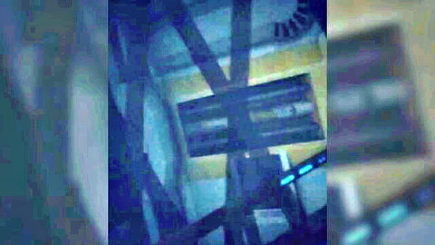 Blurry abstract image of dark wooden beams and structures under blue lighting