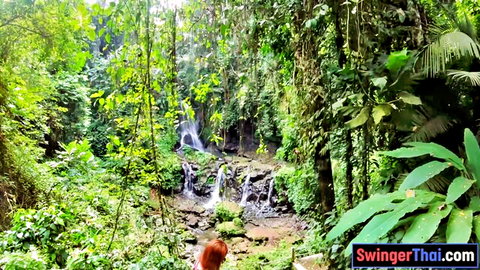 Sexy Thai girlfriend big juicy ass in shorts posing at jungle waterfall outdoors