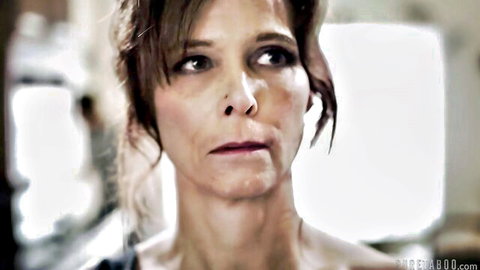 Brunette MILF with intense sultry gaze and parted lips in closeup