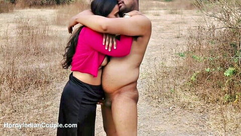Sexy Indian babe in pink top hugs naked man's erect cock outdoors in field