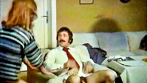 Retro threesome with lustful blonde woman touching exposed man on couch