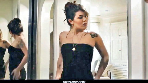 Brunette tattooed skinny babe in tight black dress posing in mirror